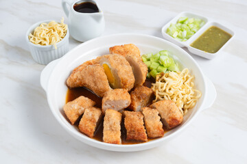Pempek, traditional food from South Sumatra, Indonesia. This fish-based food is very popular. Served with cuko sauce and cucumber slices. Perfect for recipe, article, catalogue.