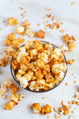 caramel popcorn in a white bowl. Perfect for recipe, article, catalogue, or any commercial purposes. with copy space.