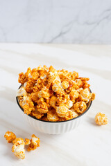 caramel popcorn in a white bowl. Perfect for recipe, article, catalogue, or any commercial purposes. with copy space.