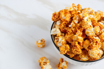 caramel popcorn in a white bowl. Perfect for recipe, article, catalogue, or any commercial purposes. with copy space.