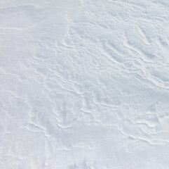 The snow is white and the ground is covered in it
