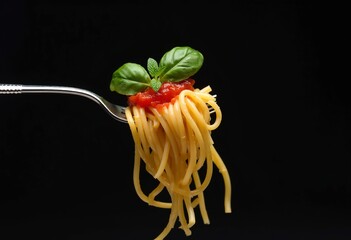 A fork holding a bundle of cooked spaghetti pasta with tomato sauce and fresh basil leaves on a dark background