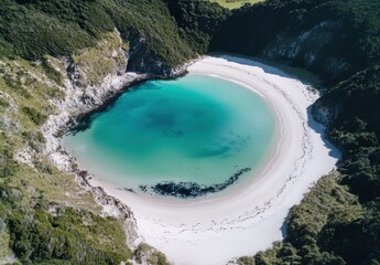 Obraz premium Aerial View of a Serene Circular Lagoon Surrounded by Lush Greenery and Soft Sandy Beach Featuring Turquoise Water in a Coastal Paradise