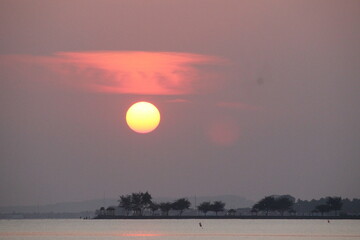 reddish orange sunrise on the morning beach