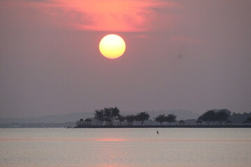 reddish orange sunrise on the morning beach