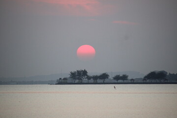 reddish orange sunrise on the morning beach