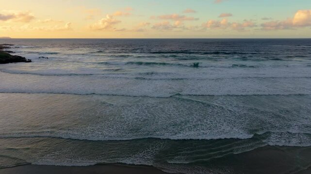 Ocean Waves Slowly Lapping On Shore. aerial, panning shot