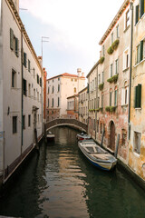 A quiet canal with boats and buildings in Venice.