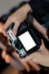 A person's hand holding a DSLR camera, as a camera mockup displays photography skills and creative potential in various settings.