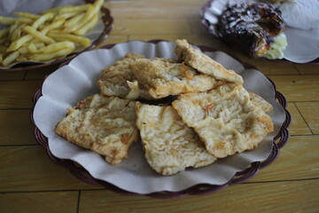 a plate of fried tempeh or mendoan, a typical Indonesian food made from soybeans, served with other...