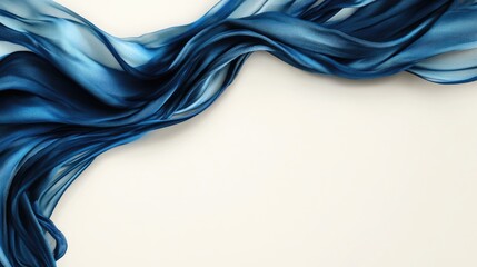 Naklejka premium Flowing blue silk fabric draped artistically on a white background creating a serene and elegant visual composition.