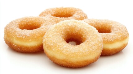 Delicious freshly baked donuts arranged appealingly on a clean white background showcasing their sugary texture and golden color.