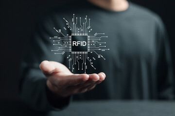 RFID, Radio Frequency Identification concept. Electronic data storage system that enhances computational capabilities and data security. Person with RFID technology on virtual screen.