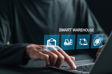 Smart warehouse management system concept, Person using laptop with smart warehouse system on virtual screen for real time monitoring products storage shipping.