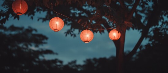 Red lanterns glowing softly against a dusky sky illuminating the serene nighttime atmosphere in a tranquil outdoor setting
