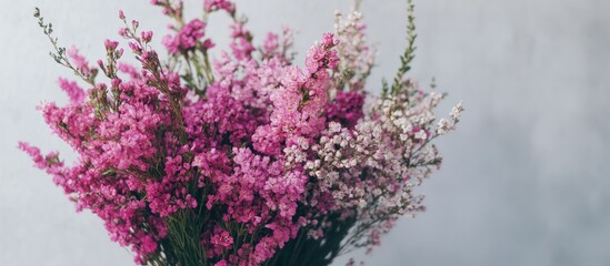 Spring bouquet of vibrant pink flowers elegantly arranged on a table against a neutral background for a cheerful atmosphere