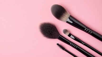 Professional makeup brushes set on a pink background perfect for beauty and cosmetics advertising or tutorials.