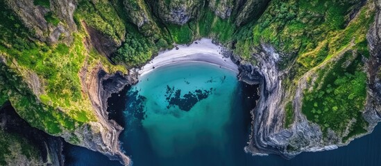 Secluded Beach Surrounded by Lush Cliffs in a National Park Aerial View