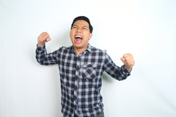 Fototapeta premium frustrated asian man screaming angry with hands raised isolated on white wearing plaid shirt