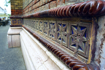 Decorative cornice with a pattern of stars at the bottom of the main façade of the Cetate Synagogue, built in the 19th century in Timisoara. A close-up of the decorations on the eclectic building