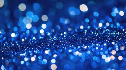 Fototapeta premium Abstract blue glitter particles with soft focus creating a shimmering underwater holiday background for festive luxury and magic themes.