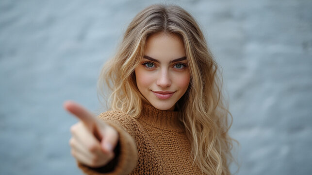 woman’s index finger pointing directly at the viewer conveying confidence, engagement, and a sense of direction with a clean and sharp focus on her gesture