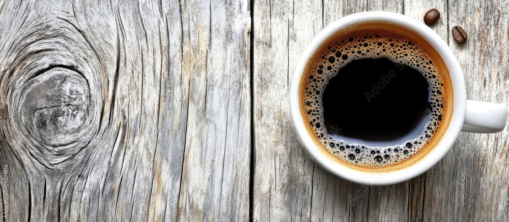 Poster cup of freshly brewed coffee on rustic wooden table with coffee beans creating a warm and inviting a