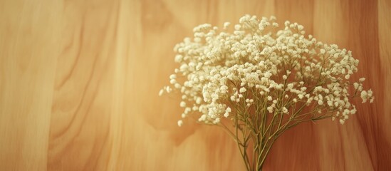 Charming white flower bouquet on a wooden table with a soft background and ample empty space for text or branding overlays