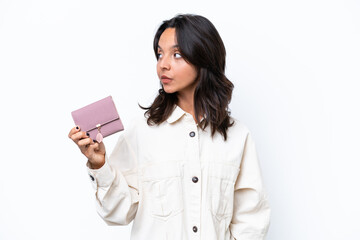 Young hispanic woman holding wallet isolated on white background looking to the side