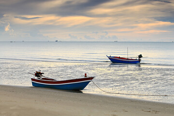 Fishing boat in sunrise background at Pranburi beach, Prachuap Khiri Khan Province, Thailand 