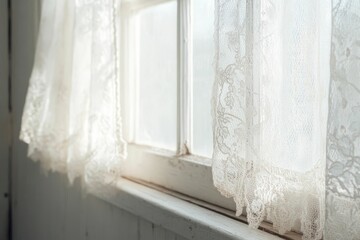 Lace curtains drape over sunlit window.
