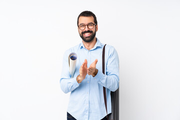 Young architect man with beard over isolated white background applauding after presentation in a...