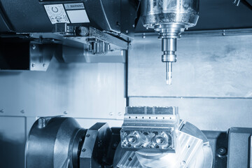 The 5-axis machining center cutting automotive parts with indexable tool in the light blue scene.