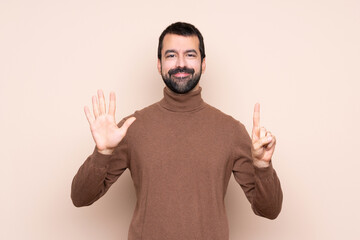 Fototapeta premium Man over isolated background counting six with fingers