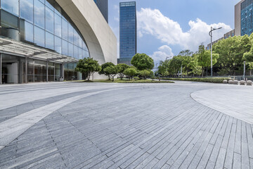 Empty brick floor and modern city buildings