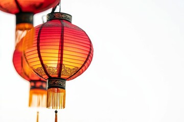 Obraz premium Red lanterns hang, tassels sway, bright background.