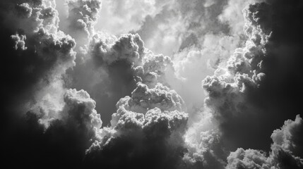 Fototapeta premium Dramatic Black and White Clouds with Rays of Light Peeking Through