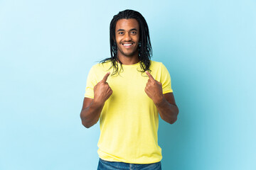 Delivery African American man with braids isolated on white background with surprise facial...