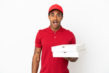 African American pizza delivery man picking up pizza boxes over isolated white wall with surprise...