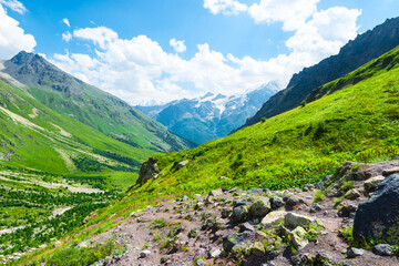 Fototapeta premium Beautiful high mountain landscape with green slopes and large stones. Caucasus, Elbrus region.