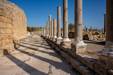 Fototapeta premium Rows of columns in Perge, Antalya, Turkey. Remains of colonnaded street in Pamphylian ancient city.Rows of columns in Perge, Antalya, Turkey. Ancient Kestros Fountain. Aksu, Antalya