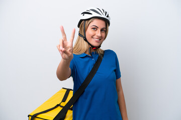 Young caucasian woman with thermal backpack isolated on white background smiling and showing victory sign