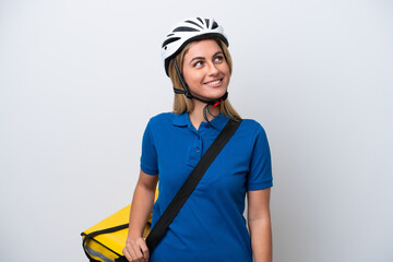 Young caucasian woman with thermal backpack isolated on white background looking side
