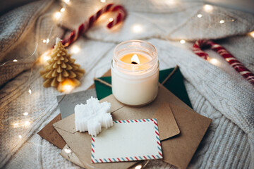 Cozy Christmas Setting with Candle, Cards, and Decorations