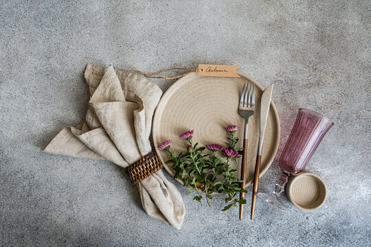 Elegant autumn table setting with rustic elements and flowers