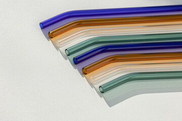 Eco friendly reusable glass straws on white background
