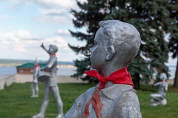Sculptures of young pioneers stand proudly in Ulyanovsk, embodying a spirit of hope and unity in a lush green park.