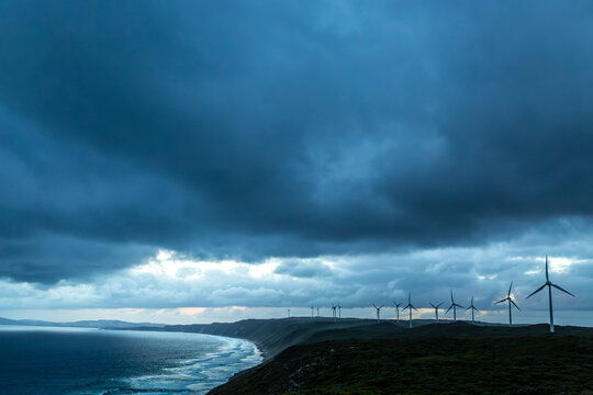 Wind turbine farm under a stormy sky at Albany, Western Australia.
