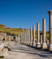 Fototapeta premium Rows of columns in Perge, Antalya, Turkey. Remains of colonnaded street in Pamphylian ancient city.Rows of columns in Perge, Antalya, Turkey. Ancient Kestros Fountain. Aksu, Antalya