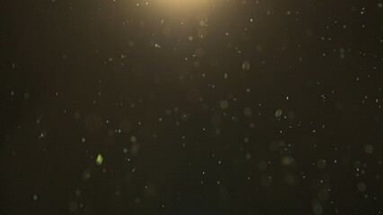 Many sparkling green glitters floating in light on empty background with light from above. Close...